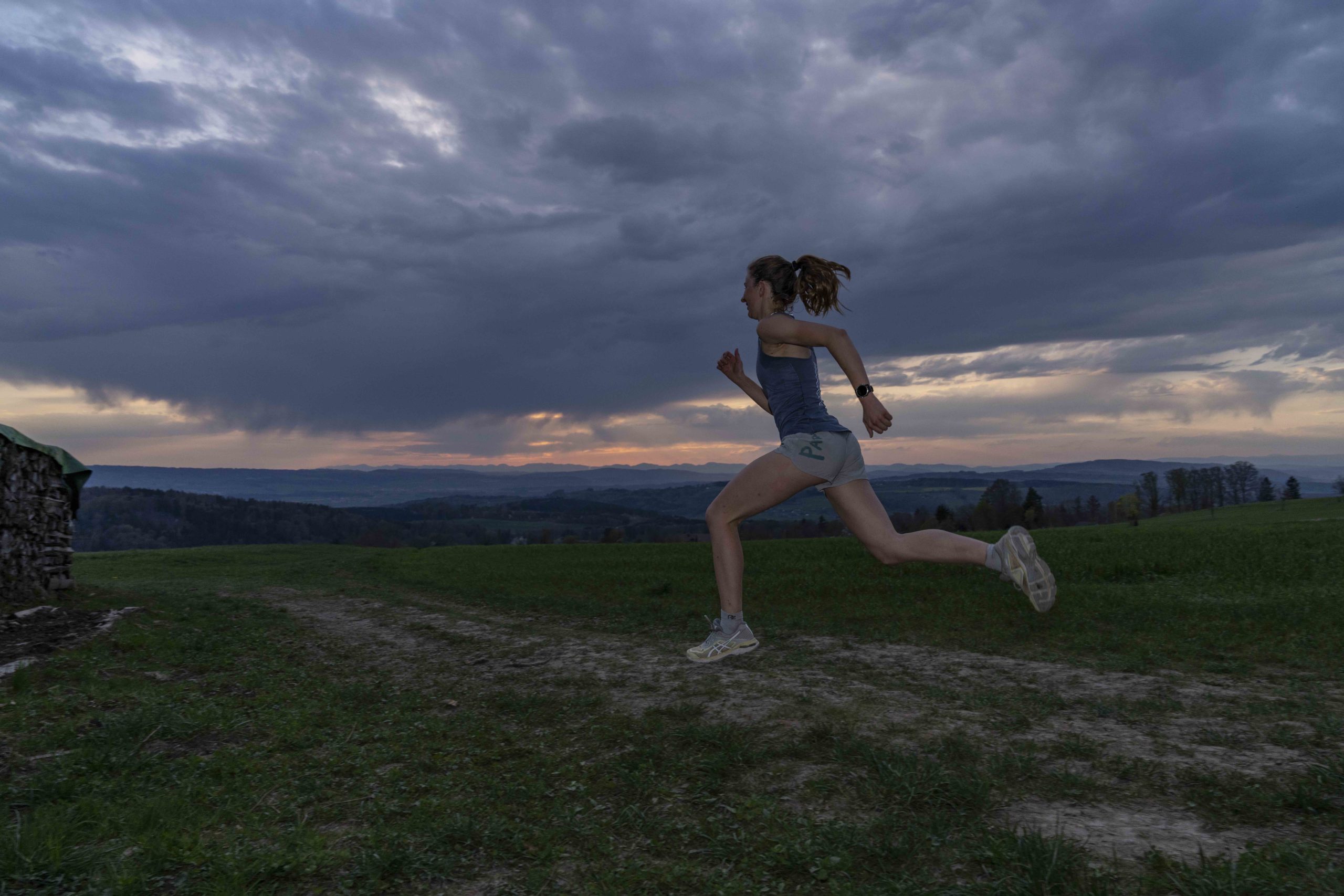 Athlete running infront of a cloudy sunset