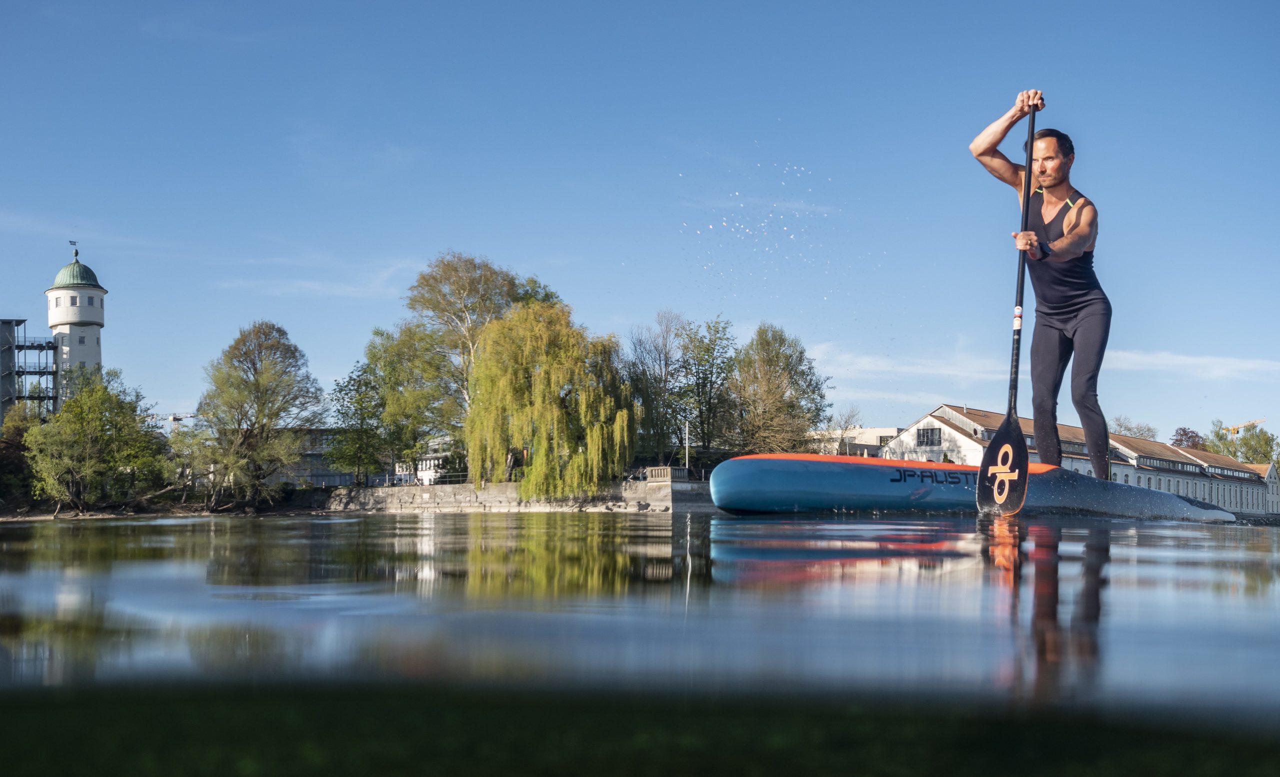 Paddler in Constance Germany with the Watertower and his reflection.